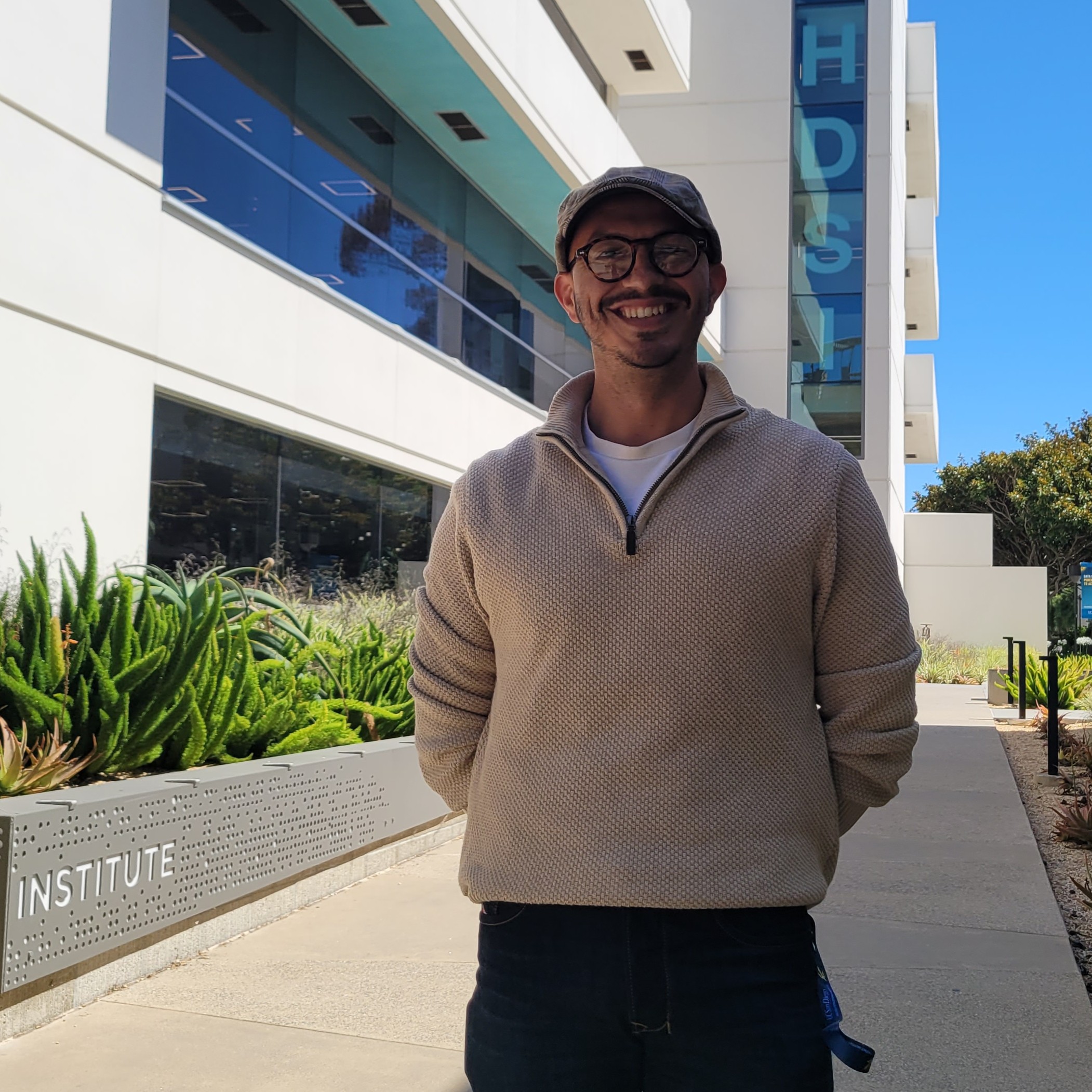 photo of a person standing in front of a white building that reads HDSI