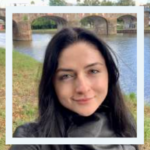 Photo of person in front of river and bridge