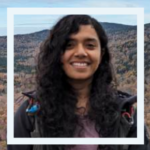Photo of person in front of hills